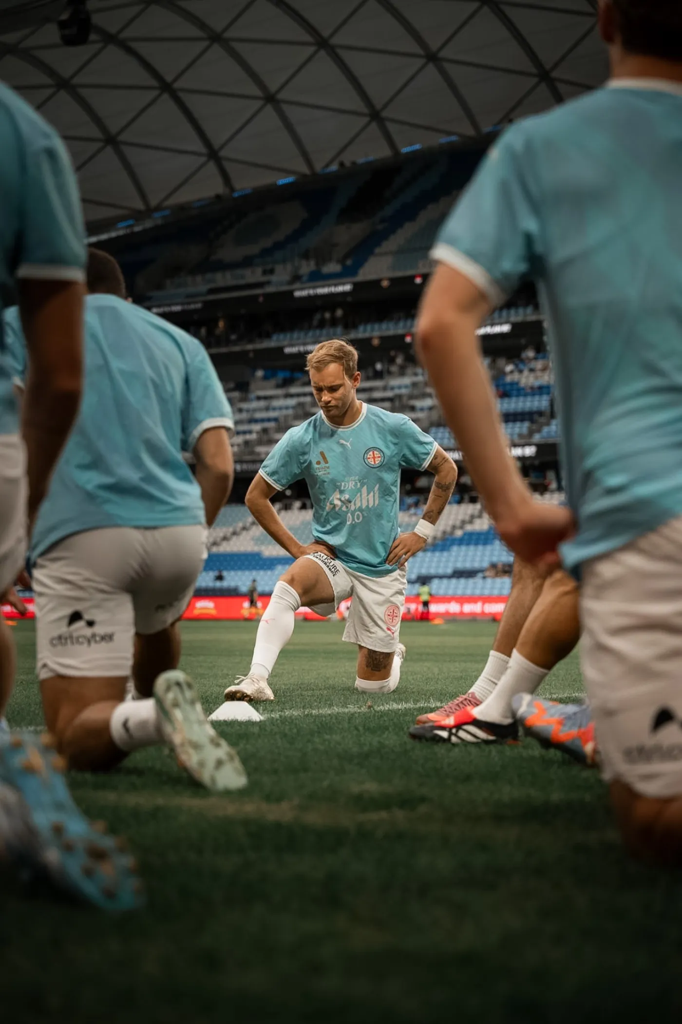 Melbourne City players stretching during pre-match warm up